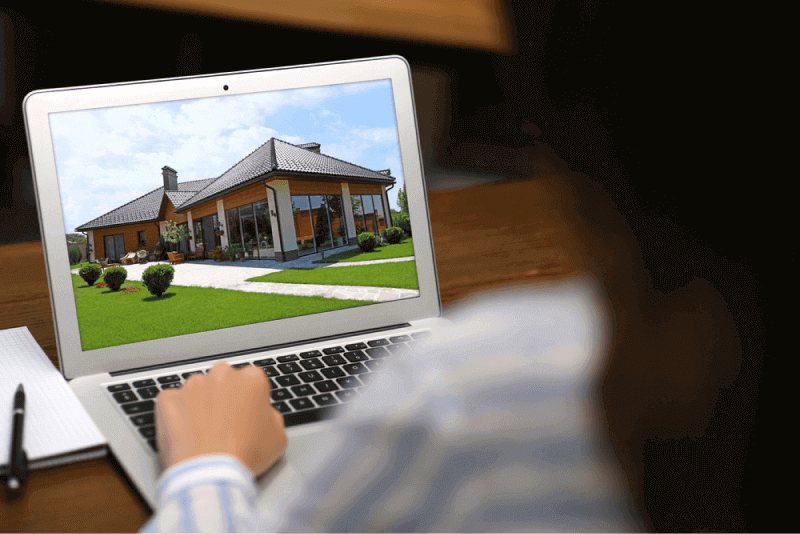 Woman looking a house through her laptop